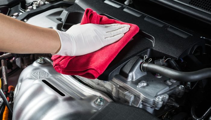 Car detailing-Closeup of hand cleaning car engine